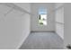 Spacious walk-in closet with carpeted floors and open shelving at 10013 Brocksport Cir, Gotha, FL 34734