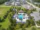 Aerial view of community pool with playground, picnic area and palm trees at 1062 Lakeside Estates Dr, Apopka, FL 32703
