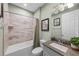 This bathroom has a shower over tub, decorative tiles, and tasteful decor at 1062 Lakeside Estates Dr, Apopka, FL 32703