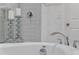 Detailed view of a soaking tub featuring stylish fixtures and decorative elements that enhance the bathroom's modern aesthetic at 1062 Lakeside Estates Dr, Apopka, FL 32703