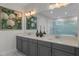 Well-lit bathroom with dual vanity, quartz countertops, large mirrors, designer lighting, and a shower with a glass enclosure at 1062 Lakeside Estates Dr, Apopka, FL 32703