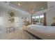 Bright bedroom with a large window and decorative tray ceiling and a view of the well-manicured exterior and landscaped lawn at 1062 Lakeside Estates Dr, Apopka, FL 32703