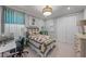 Comfortable bedroom featuring a patterned quilt, an art piece, a modern desk, and a large window providing ample light at 1062 Lakeside Estates Dr, Apopka, FL 32703