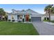 Charming single-story home with a well-maintained lawn, inviting entrance, and a two-car garage at 1062 Lakeside Estates Dr, Apopka, FL 32703