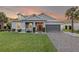 Charming single-story home with well-manicured lawn and a gray two-car garage at 1062 Lakeside Estates Dr, Apopka, FL 32703