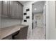 This hallway features laundry, an integrated desk, and modern wood-look flooring at 1062 Lakeside Estates Dr, Apopka, FL 32703