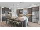 A kitchen showcases a large island with seating, stainless steel appliances, and stylish gray cabinetry at 1062 Lakeside Estates Dr, Apopka, FL 32703