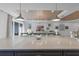 An island overlooks a living area that has large windows and comfortable seating in a well-lit space at 1062 Lakeside Estates Dr, Apopka, FL 32703