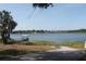 Scenic lakeside view with dock gazebo and lounge chairs at 1062 Lakeside Estates Dr, Apopka, FL 32703