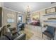 Stylish home office with custom built-ins, decorative lighting, and a comfortable seating area at 1062 Lakeside Estates Dr, Apopka, FL 32703