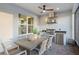This outdoor dining area features a built in outdoor kitchen and ample seating at 1062 Lakeside Estates Dr, Apopka, FL 32703