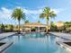 Resort-style community pool with seating and lush landscaping, perfect for relaxing at 1062 Lakeside Estates Dr, Apopka, FL 32703