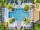 Aerial view of a community pool, surrounded by lounge chairs, lush landscaping and shaded cabanas at 1062 Lakeside Estates Dr, Apopka, FL 32703
