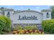 Lakeside community sign with stone base, decorative lights, and colorful landscaping at 1062 Lakeside Estates Dr, Apopka, FL 32703