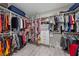 Organized walk-in closet with ample shelving, drawers, and hanging space for clothing and accessories, and wooden floors at 1062 Lakeside Estates Dr, Apopka, FL 32703