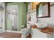 Bathroom featuring a natural wood countertop, a glass-enclosed shower, and vintage decor at 10664 Emerald Chase Dr, Orlando, FL 32836