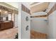 Bathroom showcasing a tiled shower, a large vanity, a walk-in shower stall, and decorative lighting at 10664 Emerald Chase Dr, Orlando, FL 32836