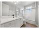 Well-lit bathroom features a white vanity, tiled floors, glass shower doors, and neutral color scheme at 10664 Emerald Chase Dr, Orlando, FL 32836