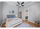 Bright bedroom with hardwood floors, ceiling fan, and an ensuite bathroom at 10664 Emerald Chase Dr, Orlando, FL 32836