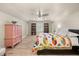 Spacious bedroom with a ceiling fan, closet and a large bed with a colorful quilt at 10664 Emerald Chase Dr, Orlando, FL 32836