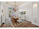 Dining room with hardwood floors, a large wooden table, and elegant lighting at 10664 Emerald Chase Dr, Orlando, FL 32836