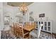 Dining room with hardwood floors, a large wooden table, and elegant lighting at 10664 Emerald Chase Dr, Orlando, FL 32836