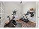 This home gym features an exercise bike, a treadmill, and hardwood floors at 10664 Emerald Chase Dr, Orlando, FL 32836