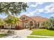 Attractive home showcasing a red tile roof, mature landscaping, and inviting curb appeal at 10664 Emerald Chase Dr, Orlando, FL 32836