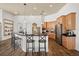 Bright kitchen with a large island, breakfast bar seating, stainless steel appliances, and wooden cabinetry at 10664 Emerald Chase Dr, Orlando, FL 32836