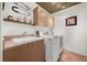 Functional laundry room with storage cabinets, sink, and modern appliances for added convenience at 10664 Emerald Chase Dr, Orlando, FL 32836
