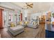 Open-concept living room with a large sectional sofa, view of the kitchen, and outdoor access at 10664 Emerald Chase Dr, Orlando, FL 32836