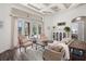 Bright living room with hardwood floors, coffered ceiling, and elegant furnishings at 10664 Emerald Chase Dr, Orlando, FL 32836