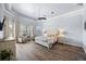 Light and airy main bedroom with hardwood floors, a decorative ceiling, and a large window with natural light at 10664 Emerald Chase Dr, Orlando, FL 32836