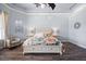 This main bedroom includes hardwood floors, a decorative ceiling with a ceiling fan and a cozy seating area at 10664 Emerald Chase Dr, Orlando, FL 32836