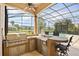 The outdoor kitchen features stainless steel appliances, a built-in grill, and a bar for entertaining at 10664 Emerald Chase Dr, Orlando, FL 32836