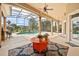 Spacious covered patio with ceiling fans and outdoor seating overlooking the pool and backyard at 10664 Emerald Chase Dr, Orlando, FL 32836