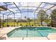 Beautiful screened-in pool with scenic lake view, perfect for relaxation and outdoor entertainment at 10664 Emerald Chase Dr, Orlando, FL 32836