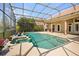 Covered patio and pool area with lush landscaping, perfect for enjoying outdoor living and relaxation at 10664 Emerald Chase Dr, Orlando, FL 32836
