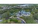 Gorgeous aerial shot of a yellow resort with a pool, hot tub, landscaping, and palm trees at 107 Rum Run # 107, Davenport, FL 33897
