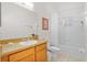 Bright bathroom features a vanity with a sink and a shower and bathtub combination with a shower curtain at 107 Rum Run # 107, Davenport, FL 33897