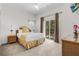 Bright bedroom with balcony access, showcasing a comfortable bed and a tropical-themed decor at 107 Rum Run # 107, Davenport, FL 33897
