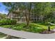 Beautiful exterior of a multi-story building featuring screened balconies and manicured landscaping at 107 Rum Run # 107, Davenport, FL 33897