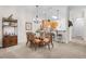 Light and airy dining room with seating for six, featuring a glass-top table and a decorative chandelier at 107 Rum Run # 107, Davenport, FL 33897