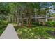Exterior view of lush landscaping and a sidewalk leading to a charming condo at 107 Rum Run # 107, Davenport, FL 33897
