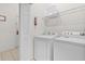 Functional laundry area with washer, dryer, wire shelving, and ample space for laundry tasks at 107 Rum Run # 107, Davenport, FL 33897