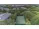 Aerial view of a well-maintained tennis court surrounded by trees in a residential community at 107 Rum Run # 107, Davenport, FL 33897