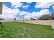 Expansive backyard features lush grass, privacy fence, and ample space for outdoor activities at 1092 Sugarwood St, Davenport, FL 33837