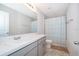 Bathroom with double sink vanity and shower with neutral walls and floors at 1092 Sugarwood St, Davenport, FL 33837