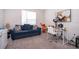 Bedroom with comfortable seating, plush carpet, and natural light for versatile use at 1092 Sugarwood St, Davenport, FL 33837