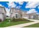 Charming two-story home with manicured lawn, front garden, and attached two car garage at 1092 Sugarwood St, Davenport, FL 33837